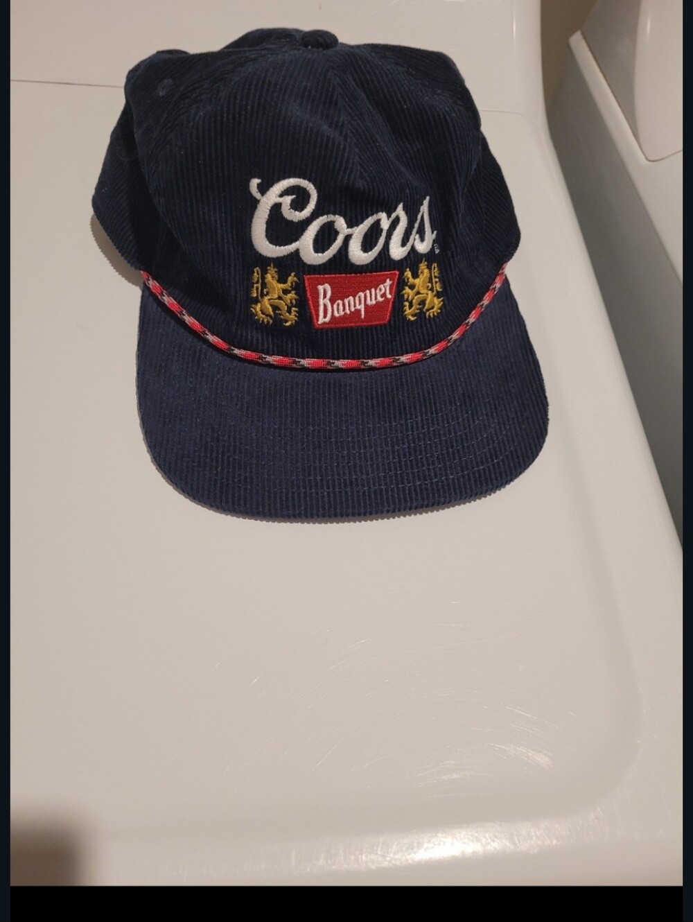 navy blue corduroy cap appears to be the Coors Banquet Navy Corduroy Cap